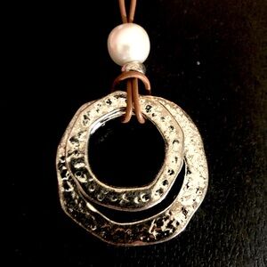 Stylish silver circle pendant with long brown leather necklace